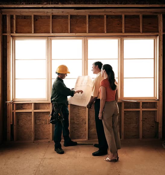 R&F contractor reviewing blueprints with homeowners on site
